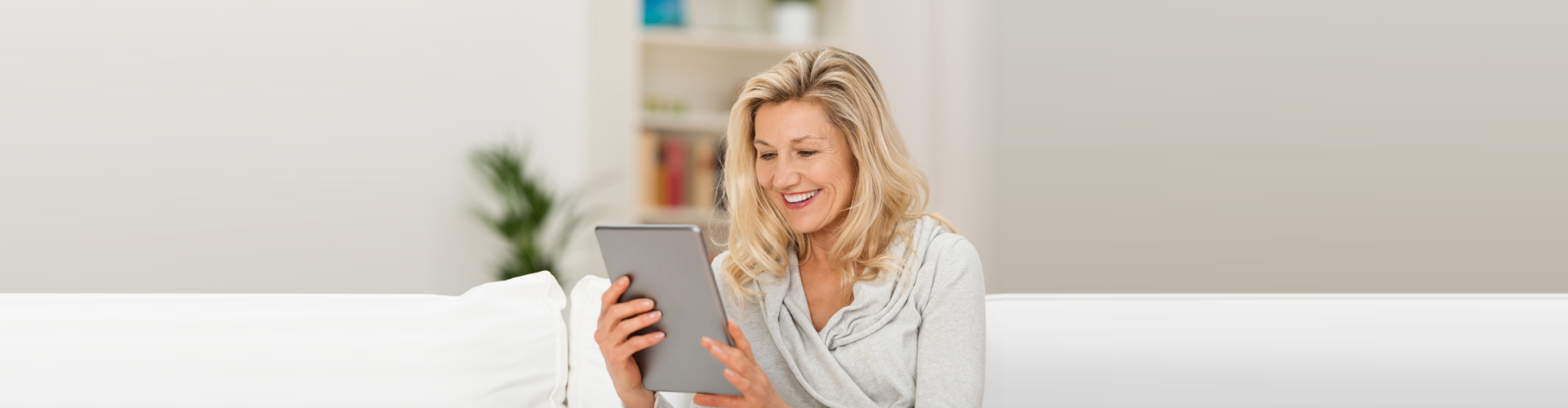senior woman using a tablet smiling